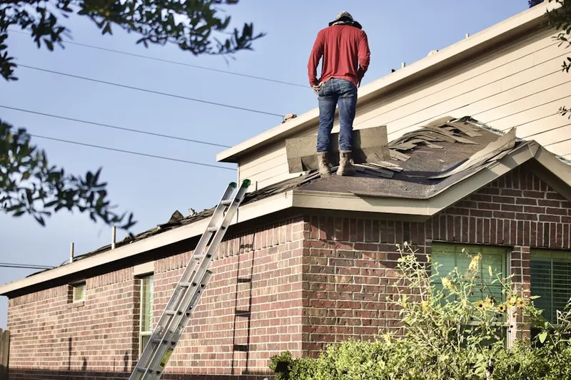 Professional roofer working on a residential roof in North Smithfield